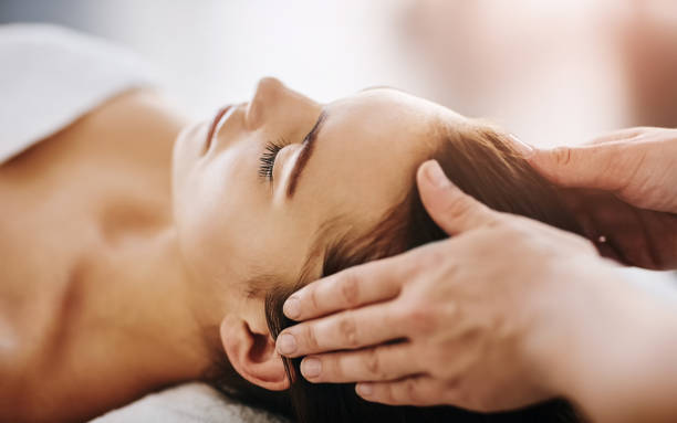 Cropped shot of a beautiful young woman getting a head massage at a spa